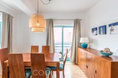 a dining room with a wooden table and chairs and a dining room at Marina Water View - 6 people, bars & restaurants in Albufeira