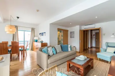 a living room with a couch and a table at Marina Water View - 6 people, bars & restaurants in Albufeira