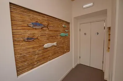 a hallway with a wall with fish on it at Son of a Beach Hostel in Albufeira