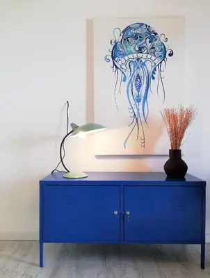 a blue cabinet with a painting of an octopus at Son of a Beach Hostel in Albufeira