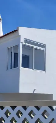 a white building with windows and a lighthouse at Quinta Shiamar in Quarteira