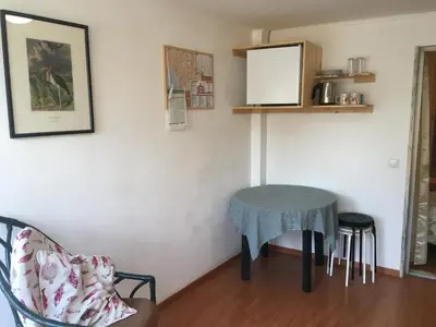 a living room with a table and a chair at Rua Fancisco Barreto in Faro