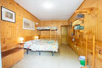 a bedroom in a log cabin with a bed and shelves at Rua Fancisco Barreto in Faro