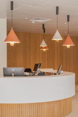 an office lobby with a counter with laptops on it at Hapimag Resort Albufeira in Albufeira