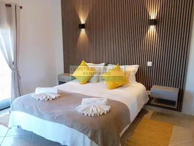 a bedroom with a large bed with yellow pillows at Moradia Townhouse S Sebastião F in Guia