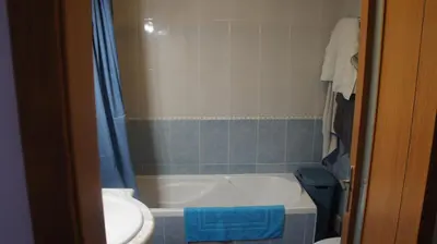 a bathroom with a tub and a toilet and a sink at Pool & Garden Oura Albufeira Flat in Albufeira