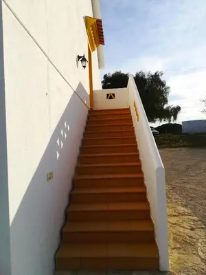 a stairway leading up to a building with at Quinta Das Palmeiras in Quarteira