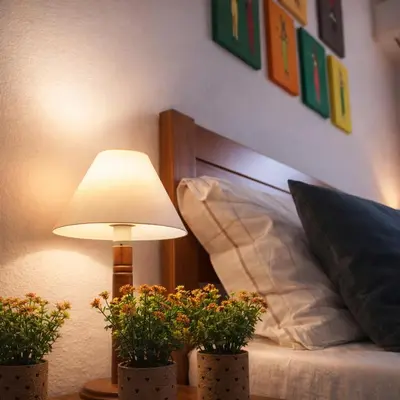 a bedroom with a bed with a lamp and some plants at Fisherman´s beach apartment in Albufeira