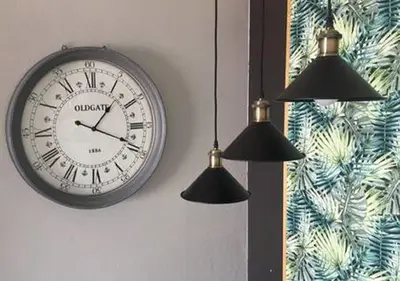 a clock hanging on a wall with two lights at Fisherman´s beach apartment in Albufeira
