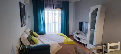 a bedroom with a bed and a tv and a chair at Fisherman´s beach apartment in Albufeira