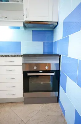 a blue and white kitchen with an oven at Old Town Sant'ana T2 in Albufeira