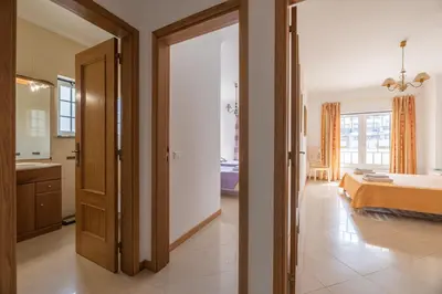 a room with a bedroom with a bed and a bathroom at Apartamento Praia da Oura in Albufeira
