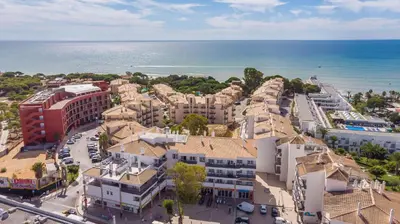 an aerial view of a city with the ocean at Apartamento Praia da Oura in Albufeira