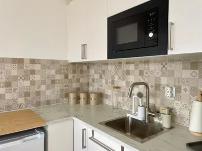 a kitchen with a sink and a microwave at RosaMar apartment sea view and pool in Albufeira