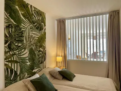 a bedroom with a bed and a large window at RosaMar apartment sea view and pool in Albufeira
