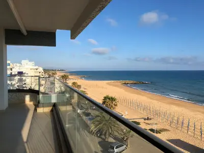 a view of the beach from the balcony of a condo at ocean blue in Quarteira