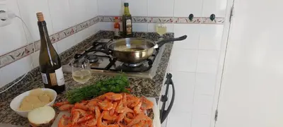 a kitchen counter with a stove and a plate of food at KAP Sea View Balcony in Albufeira