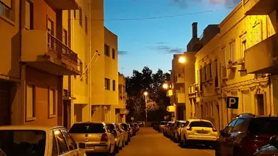 a city street with cars parked on the street at Hostel A Casa da Árvore in Faro