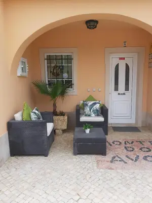 a patio with two couches and a white door at Apartamentos Monte dos Avós, Albufeira by AlgarveBlossom in Albufeira