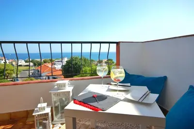 a table with two glasses of wine on a balcony at Apart JCMar - Near to the beach - WIFI - BY BEDZY in Albufeira