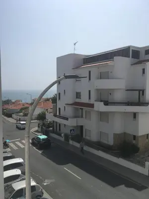 a tall white building with cars parked in front of it at Apart JCMar - Near to the beach - WIFI - BY BEDZY in Albufeira