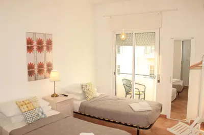 a bedroom with a bed and a couch and a table at Casa da avó Bia in Faro