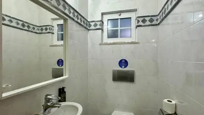 a bathroom with a sink and a mirror and a toilet at Fonte Santa by Check-in Portugal in Quarteira