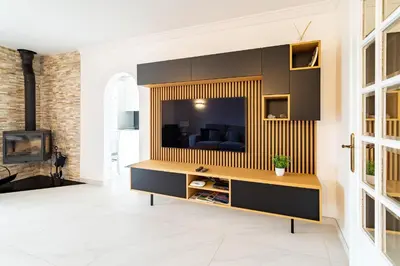 a living room with a tv on a wall at Casa beira mar Algarve in Albufeira