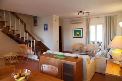a living room with a couch and a table at Marina Apartment in Quarteira