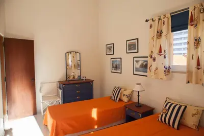 a bedroom with a bed and a dresser and a mirror at Marina Apartment in Quarteira
