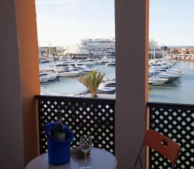 a balcony with a view of a marina with boats at Marina Apartment in Quarteira