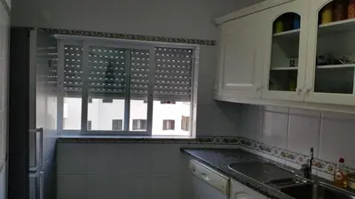 a kitchen with a sink and a window in it at Austral Apartment in Quarteira