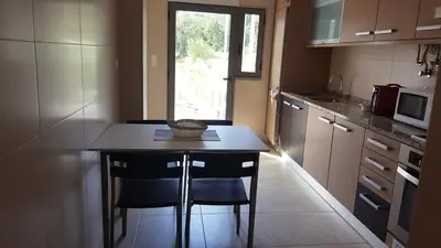 a small kitchen with a table and two chairs at Plaza 305 Albufeira in Albufeira