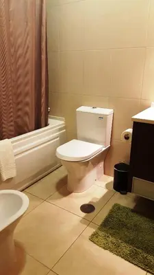 a bathroom with a toilet and a sink and a shower at Plaza 305 Albufeira in Albufeira