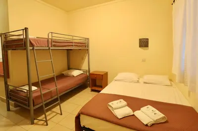 two bunk beds in a room with an orange curtain at Rialgarve in Faro