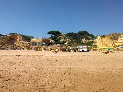 a beach with a group of people and umbrellas at Vista Mar 2 in Albufeira