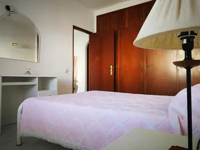 a bedroom with a white bed and a window at Vista Mar 2 in Albufeira