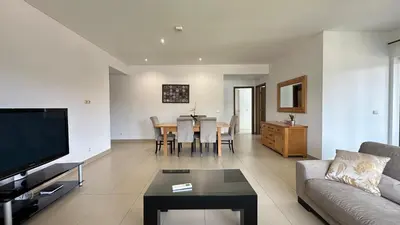 a living room with a couch and a table at Cavalo Prеto Holiday apartment 200m to the beach in Quarteira