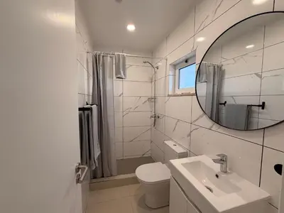a bedroom with a bed and a large window at Guest House Dianamar in Albufeira