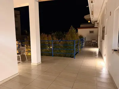 a bedroom with a bed and a sliding glass door at Guest House Dianamar in Albufeira