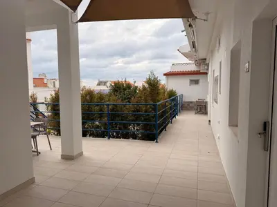 a bedroom with a bed and a tv on a wall at Guest House Dianamar in Albufeira