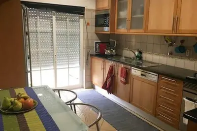 a kitchen with a table with a bowl of fruit on it at Your place in Faro in Faro