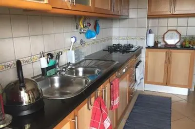 a kitchen with a sink and a stove at Your place in Faro in Faro