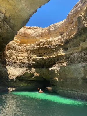 a person in a kayak in a cave in the water at sol nascente in Vilamoura