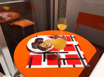 a table with a plate of food and two glasses of wine at Zesty Orange by ITHOUSE in Albufeira