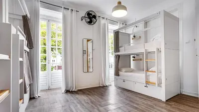 a bedroom with a bunk bed with a mirror at Hostel Casa d'Alagoa in Faro