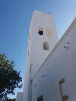 a white tower with windows on the side of it at Guest House Capitao Mor in Faro