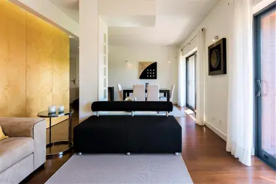 a living room with a couch and a table at L'Orangerie in Vilamoura