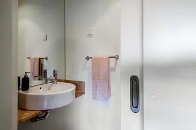a white bathroom with a sink and a mirror at L'Orangerie in Vilamoura