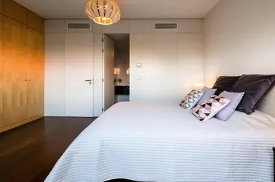 a bedroom with a large white bed with pillows on it at L'Orangerie in Vilamoura